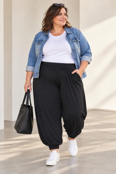Čierne dámske plus size háremové nohavice zo širokého elastického džerseja s pružným pásom, bočnými vreckami a patentmi na členkoch