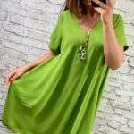 Limetkovozelené voľné šaty s výstrihom do V a krátkymi rukávmi, vhodné pre moletky, s výrazným náhrdelníkom