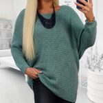 Mäkký mätový pletený sveter, voľný strih, dĺžka 74 cm, modelka v čiernych nohaviciach.