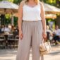 Plus size široké viskózové nohavice v béžovom odtieni s elastickým pásom a vreckami