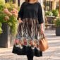 Plus size žena v čiernych midi šatách s dlhými rukávmi a saténovou sukňou so zvieracím a kvetinovým vzorom.